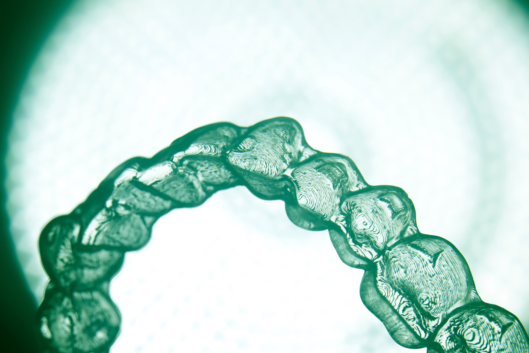 Close-up of an invisible teeth aligner bracket