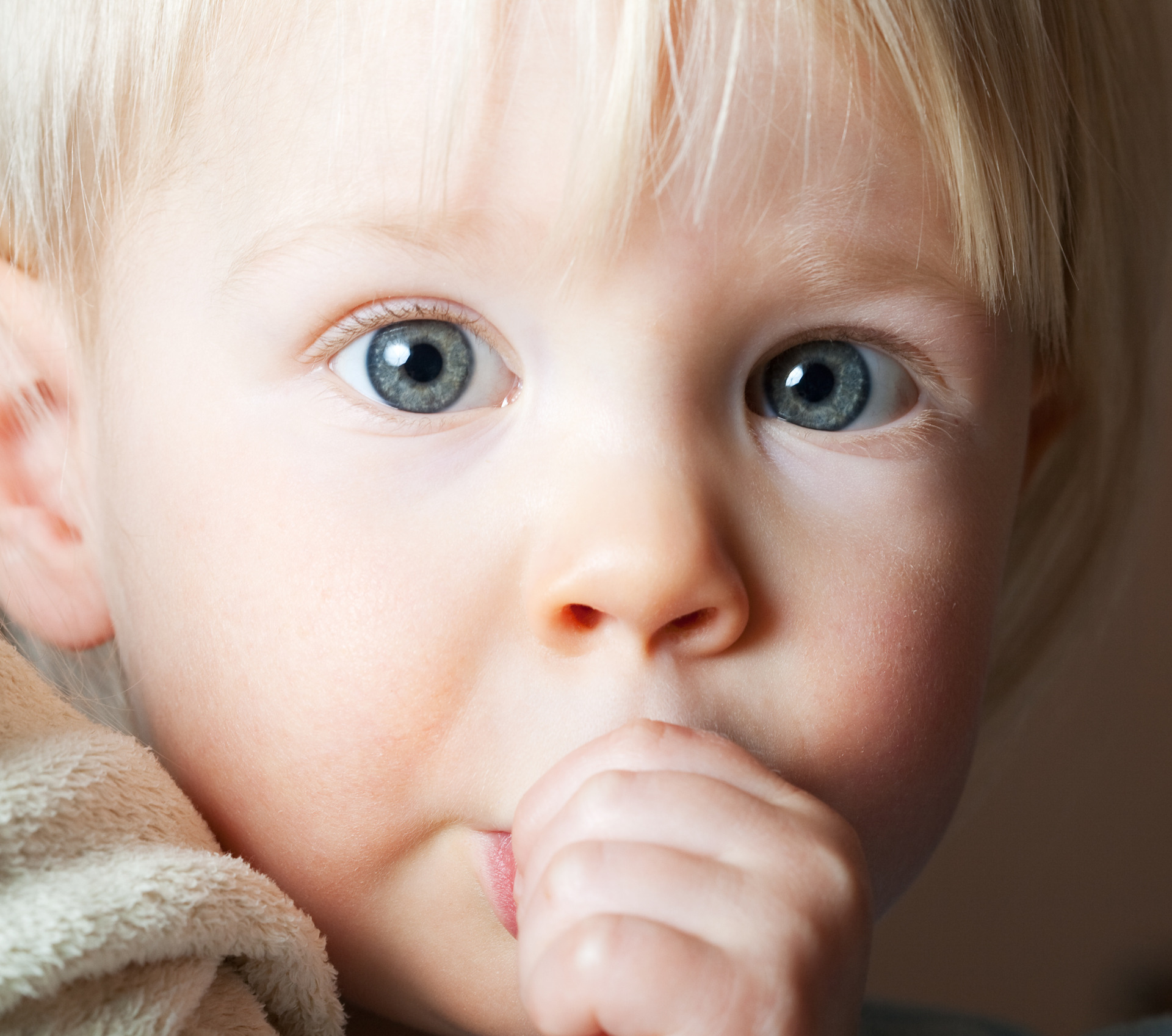 Two year old boy sucking his thumb
