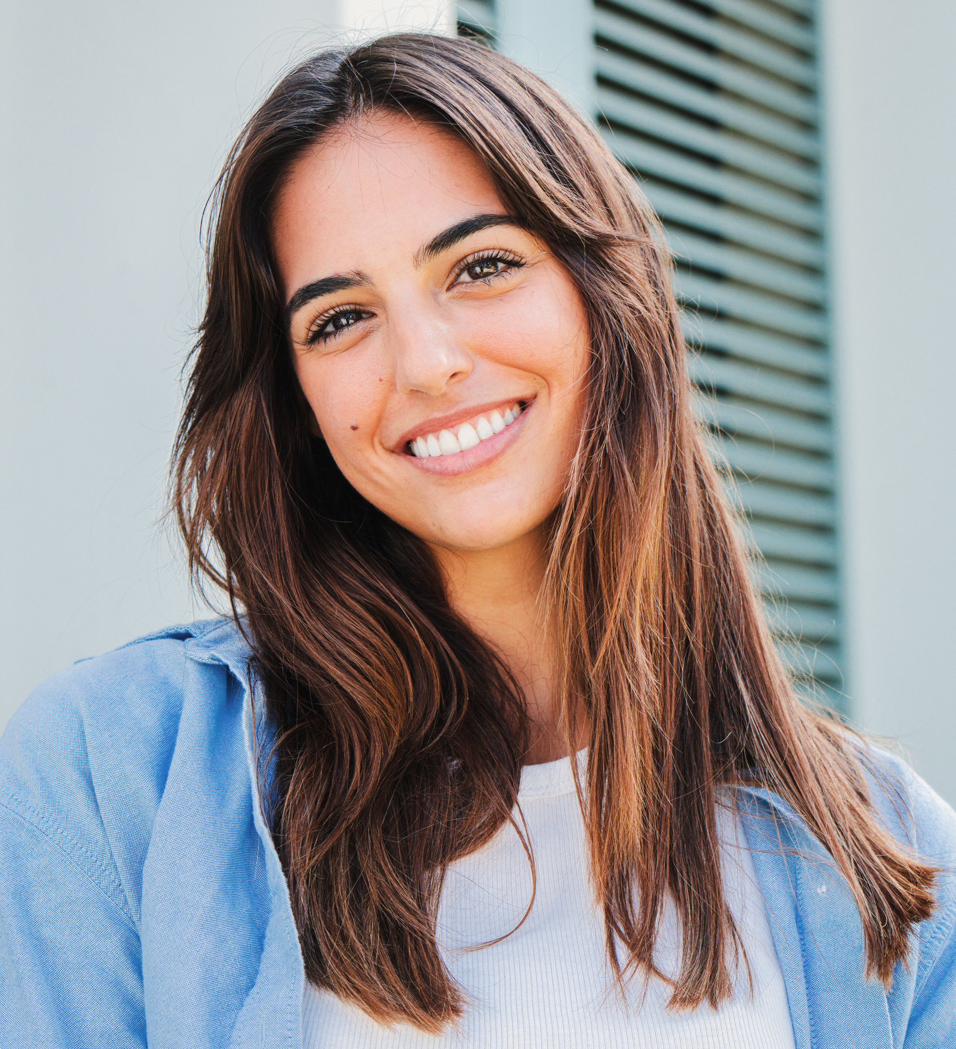 Joyful teenage brunette woman smiling with perfect teeth